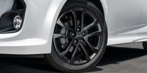 Close view of the front tire area of a white 2020 Chevrolet Sonic. | Chevrolet dealer in St. Louis, MO.