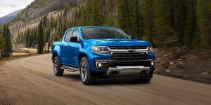 A bright blue 2021 Chevy Colorado being driven on the road. | Chevy dealer in St. Louis, MO